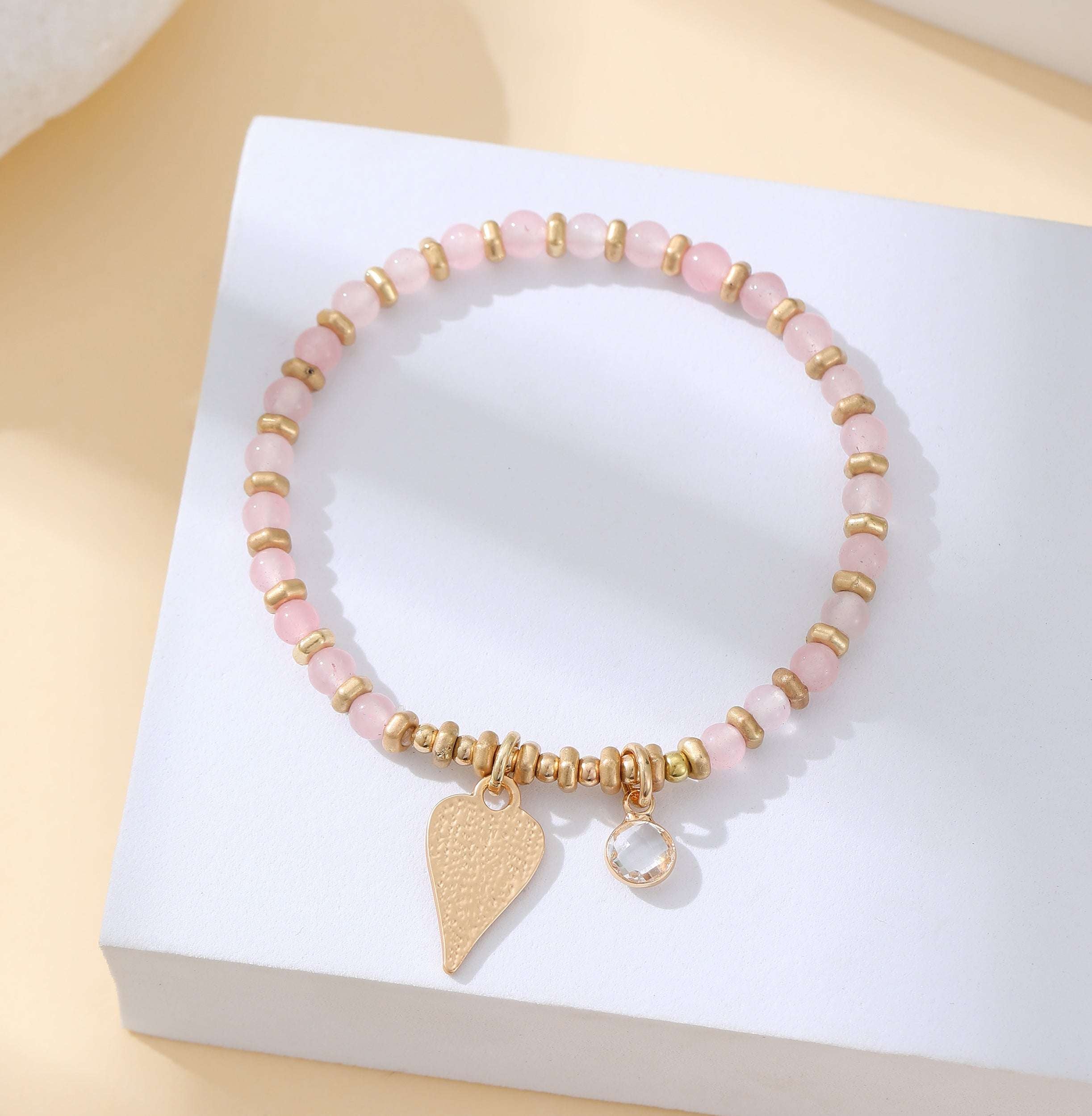Gold and blush pink stretchy heart bead bracelet
