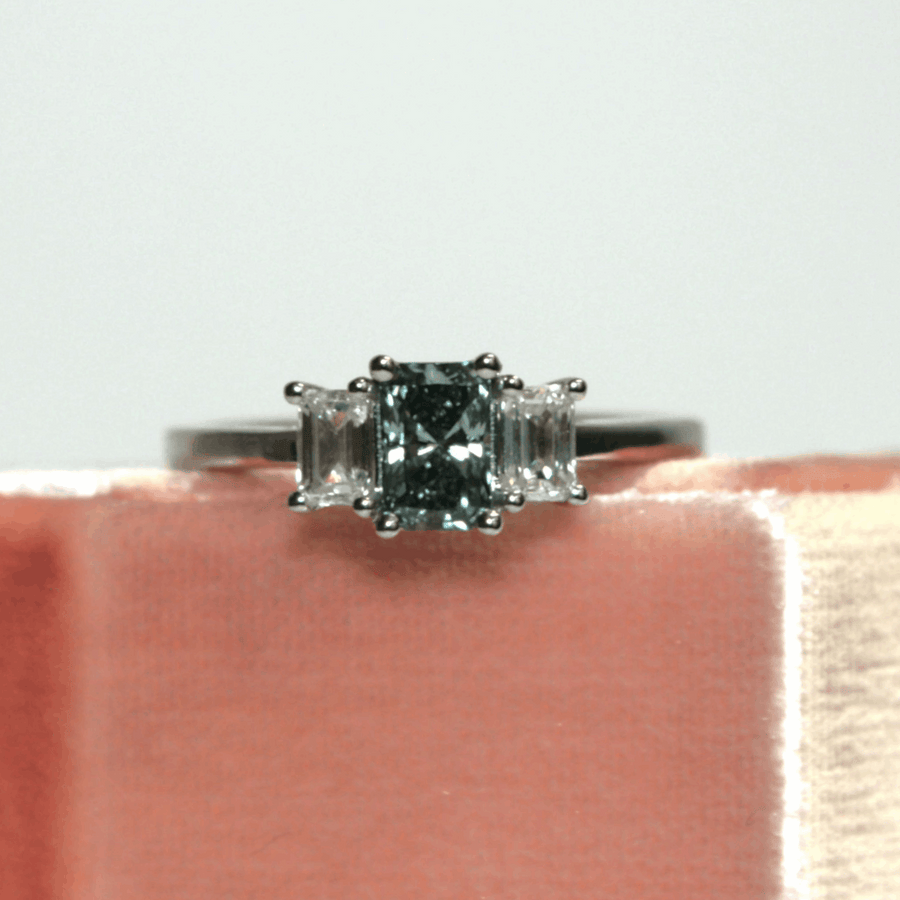 Blue Lab Grown Diamond Trilogy With Emerald Cut Stones And A Green Diamond Engagement Ring